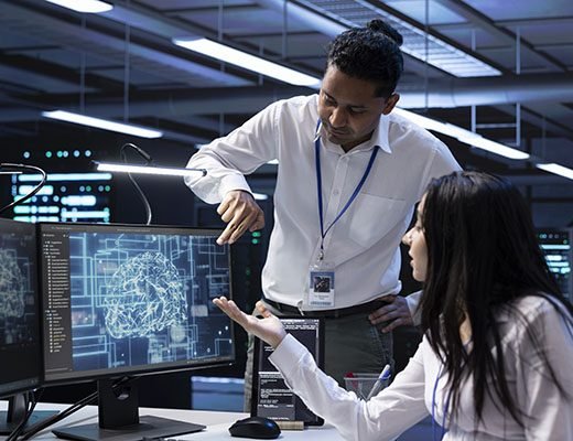 Teamworking colleagues in data center using PC to enable artificial intelligence Team of data researchers using AI tech to do checkup in server room providing storage. Teamworking colleagues in data center using PC to enable artificial intelligence to process datasets for training